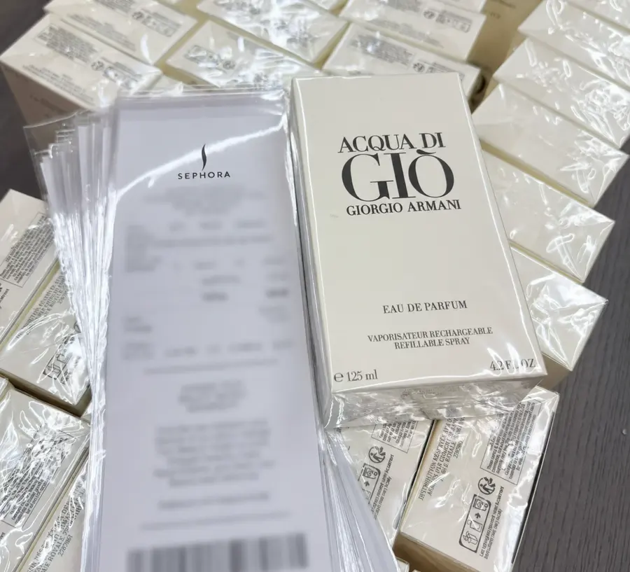 Redacted retail purchase record shown beside Acqua di Giò packaging